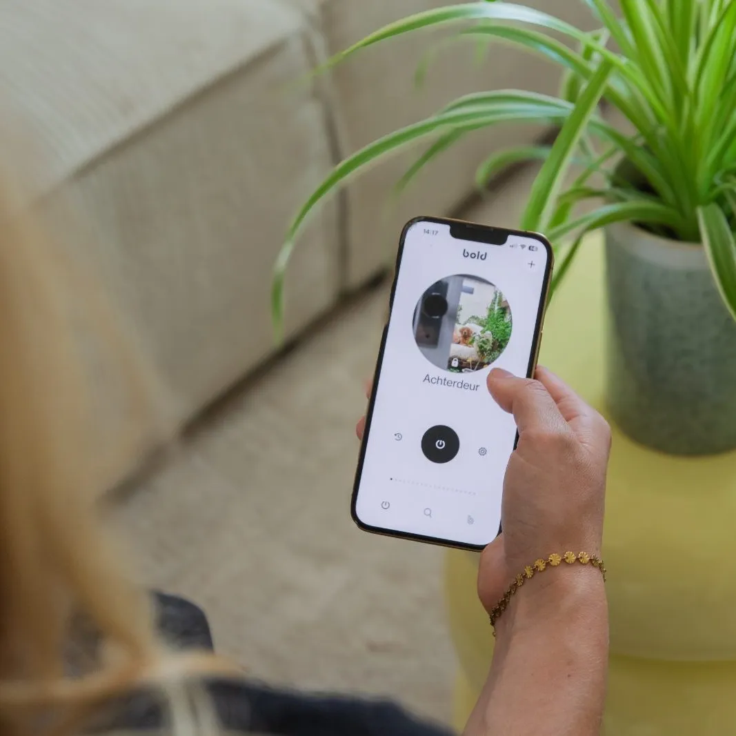 The Bold app in a hand, showing a door's locked status